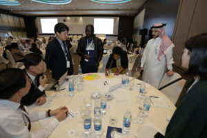 Participants in a small group discussion during the 2019 JLN Global Meeting.