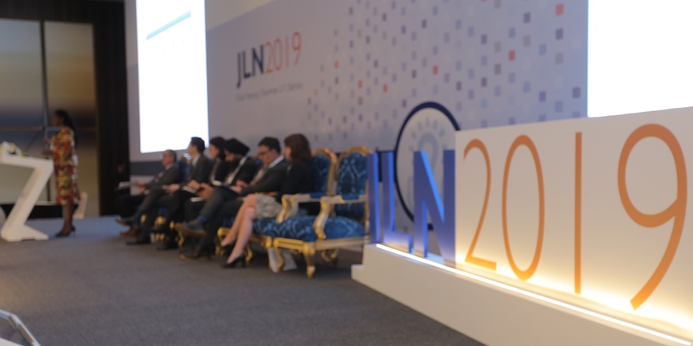 Discussants on stage during a plenary session at the 2019 JLN Global Meeting.